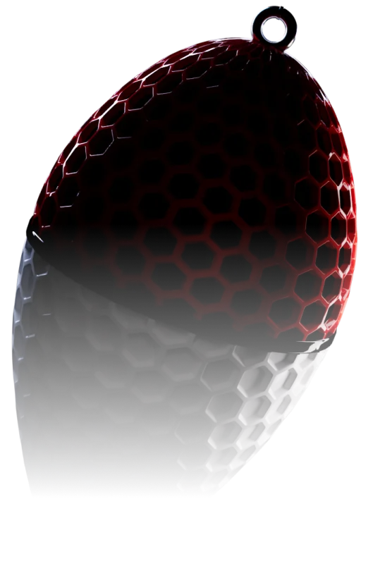 A hexagon-patterned object with a red upper half and black lower half, hanging against a black background.